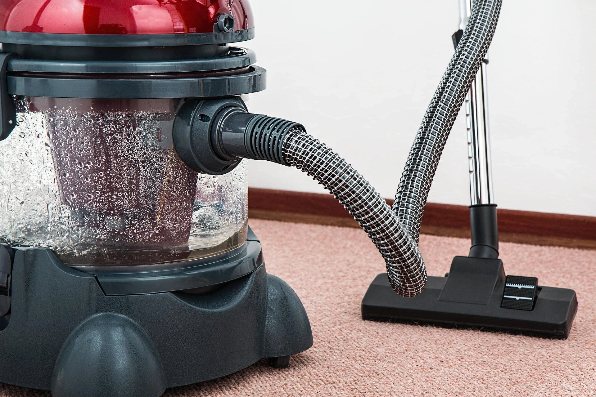 Powerful vacuum cleaner on carpet for maintenance cleaning by KD Home Cleaning